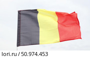 Waving flag of Belgium against a cloudy sky. Стоковое видео, видеограф Яков Филимонов / Фотобанк Лори