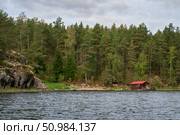 Wooden bathhouse and boat pier on the shore of Lake Ladoga near the village of Lumivaara on a sunny autumn morning, Ladoga Skerries, Lahdenpohya, Republic of Karelia, Russia. Стоковое фото, фотограф Ula Ulachka / Фотобанк Лори