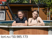 Two teenage sisters swimming in the pool. Стоковое фото, фотограф Андрей Аркуша / Фотобанк Лори