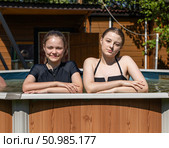 Two teenage sisters swimming in the pool. Стоковое фото, фотограф Андрей Аркуша / Фотобанк Лори