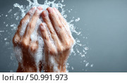 Washing hands with soap and water creates foam and splashes. Стоковое фото, фотограф Юрий Поздников / Фотобанк Лори