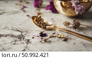 Golden spoon with dried flowers on marble surface in beautifully arranged space. Стоковое AI-видео, аниматор Сергей Толмачёв / Фотобанк Лори