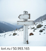 A rustic wooden signpost stands tall in a snowy landscape, directing adventurers toward Snow Mountain North. Clouds loom overhead, creating a tranquil winter atmosphere Generative AI. Стоковое AI-изображение, AI-художник Юлия Петровская / Фотобанк Лори