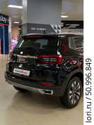 Vitebsk, Belarus - January 2, 2025: Promotional Shot of a Black Tiggo 4 Pro SUV, a Compact Automotive Vehicle, Rear End with Visible Logo and Tail Light, in Indoor Setting. Редакционное фото, фотограф Данила Большаков / Фотобанк Лори