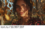 Beautiful young woman in a floral dress surrounded by autumn leaves during golden hour at a serene outdoor location. Стоковое AI-видео, аниматор Сергей Толмачёв / Фотобанк Лори