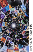 Spinning vinyl records swirling dynamically through luminous musical vortex, representing nostalgic sound experience with golden hued light emerging from spiraling album covers. Стоковое AI-видео, аниматор Данил Руденко / Фотобанк Лори