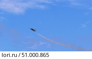 Jet ascends vertically with contrail visible behind, highlighting dynamic nature of stunt flying in open sky environment with scattered clouds below. Стоковое видео, видеограф Strunov David / Фотобанк Лори