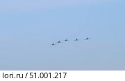 Five aircraft soar in close formation above clouds, leaving trail of white smoke as they execute synchronized aerial maneuvers against backdrop of clear sky. Стоковое видео, видеограф Strunov David / Фотобанк Лори