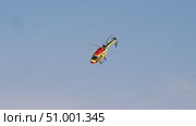 A close-up of a bright yellow-red helicopter with medical symbols, flying fast against the sky, responding to an urgent call. Стоковое видео, видеограф Strunov David / Фотобанк Лори