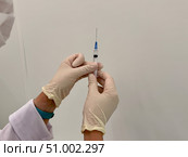 A medical officer in a white coat holds a syringe. Vaccination. Стоковое фото, фотограф Соболева Наталия / Фотобанк Лори