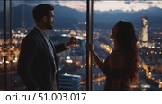 Couple enjoys a romantic moment in a high-rise building overlooking the city skyline at sunset. Стоковое AI-видео, аниматор Сергей Толмачёв / Фотобанк Лори