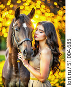 Woman With Long Brown Hair and Olive Eyes Tenderly Touches a Dark Horse in a Field. Generative AI. Стоковое AI-изображение, AI-художник Roman Zavorotny / Фотобанк Лори