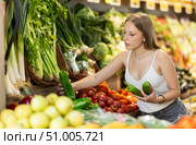 Woman near vegetable stand in store choose bell pepper. Стоковое фото, фотограф Яков Филимонов / Фотобанк Лори