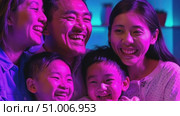 Laughter fills the air as a family enjoys a lively gathering, sharing smiles and warmth in a colorful setting this October. Стоковое AI-видео, аниматор Данила Большаков / Фотобанк Лори
