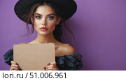 A model poses elegantly holding a blank board, emphasizing her fashion choice and striking features against a bold purple backdrop. Стоковое AI-видео, аниматор Данила Большаков / Фотобанк Лори