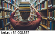 A person skillfully balances books on their head in a tranquil library atmosphere surrounded by towering shelves filled with various titles. Стоковое AI-видео, аниматор Данила Большаков / Фотобанк Лори