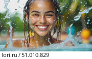 A cheerful girl with wet hair laughs as she splashes in the clear water of a sunny pool, highlighting the joy of summer days. Стоковое AI-видео, аниматор Данила Большаков / Фотобанк Лори