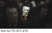 Mysterious gathering of masked figures in an eerie atmosphere during a nighttime event. Стоковое AI-видео, аниматор Сергей Толмачёв / Фотобанк Лори