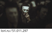 Masked figures gather in darkness for a mysterious event showcasing anonymity and intrigue. Стоковое AI-видео, аниматор Сергей Толмачёв / Фотобанк Лори