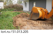 Excavation work is currently underway in close proximity to the residential house nearby. Стоковое фото, фотограф Громов Александр / Фотобанк Лори