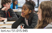 Students collaborate in a discussion, sharing ideas and insights in a vibrant classroom filled with creativity and learning. Стоковое AI-видео, аниматор Данила Большаков / Фотобанк Лори