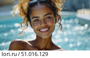 A young woman smiles joyfully while relaxing in a pool on a bright sunny day, radiating happiness and carefree vibes. Стоковое AI-видео, аниматор Данила Большаков / Фотобанк Лори