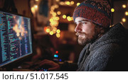 A focused individual writes code on a computer during a late-night session in a warmly lit environment. Стоковое AI-видео, аниматор Данила Большаков / Фотобанк Лори
