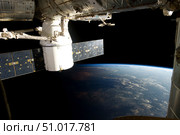 SpaceX Dragon during its docking with the International Space Station. Стоковое фото, фотограф Stocktrek Images, Inc. / ТАСС / Фотобанк Лори