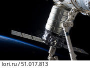 The Cygnus spacecraft attached to the Harmony Node in the grasp of Canadarm2. Стоковое фото, фотограф Stocktrek Images, Inc. / ТАСС / Фотобанк Лори