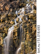 Brine falls from volcanic rock drop off to a runoff stream. Стоковое фото, фотограф Stocktrek Images, Inc. / ТАСС / Фотобанк Лори