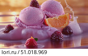 Indulge in a delightful serving of creamy raspberry ice cream topped with fresh orange slices and vibrant berries, perfect for any dessert lover. Стоковое AI-видео, аниматор Данила Большаков / Фотобанк Лори