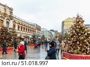 MOSCOW, RUSSIA - January 3, 2021: New Year's colorful trees in front of the Central Department Store in Moscow on Kuznetsky Most. Редакционное фото, фотограф Ольга Сейфутдинова / Фотобанк Лори