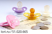 Children's pacifiers at the birth certificate. The concept of maternity capital. Стоковое фото, фотограф Igor Skripachev / Фотобанк Лори