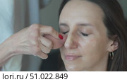 Makeup sponge face: Woman gets foundation applied indoors during daytime for enhanced appearance. Стоковое видео, видеограф svetograph / Фотобанк Лори