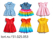 Colorful collection of baby dresses, isolated on a white background. Different styles and colors clothes for baby girls. Rainbow ruffle skirt, denim shirt top, party gown, cotton short-sleeve dresses. Стоковое AI-изображение, AI-художник Марина Демидюк / Фотобанк Лори