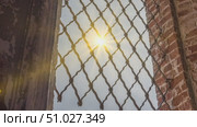 A window with the remains of a lattice in a ruined old red brick church (2022 год). Стоковое видео, видеограф Marina Gabdullina / Фотобанк Лори
