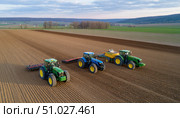 Farmers working on field with tractors and agricultural machinery. Стоковое AI-изображение, AI-художник Юрий Поздников / Фотобанк Лори