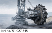 Giant bucket wheel excavator mining coal in open pit mine. Стоковое AI-изображение, AI-художник Юрий Поздников / Фотобанк Лори