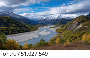 Meandering river flows through colorful autumn valley in alaska. Стоковое AI-изображение, AI-художник Юрий Поздников / Фотобанк Лори