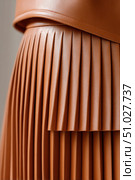 Brown pleated faux leather skirt with stitching detail. Стоковое AI-изображение, AI-художник Юрий Поздников / Фотобанк Лори