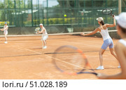 Woman playing tennis against female opponent on tennis court. Стоковое фото, фотограф Яков Филимонов / Фотобанк Лори