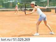 Woman playing tennis against female opponent on tennis court. Стоковое фото, фотограф Яков Филимонов / Фотобанк Лори
