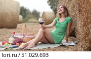 Woman in dress sitting with wine during picnic. Стоковое видео, видеограф Яков Филимонов / Фотобанк Лори