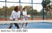 adult man paddle tennis player during friendly doubles pair match with guy partner at outdoors court. Стоковое видео, видеограф Яков Филимонов / Фотобанк Лори