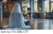 A person in a white cloak meditates peacefully in a bright, open office environment filled with plants and warm light. Стоковое AI-видео, аниматор Данила Большаков / Фотобанк Лори