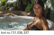 A model unwinds in a hot tub, basking in the warmth of the sun and surrounded by vibrant tropical foliage on a serene afternoon. Стоковое AI-видео, аниматор Данила Большаков / Фотобанк Лори