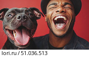 A man and his black dog share a moment of laughter and happiness, showcasing their strong bond against a bright red backdrop. Стоковое AI-видео, аниматор Данила Большаков / Фотобанк Лори