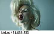 In a creative studio, a young woman expresses raw emotion through movement, her flowing blonde hair accentuating her passion and energy. Стоковое AI-видео, аниматор Данила Большаков / Фотобанк Лори