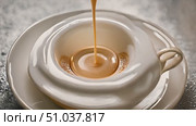 Cup of hot coffee is carefully poured into a saucer, showing the rich color and steam rising from the beverage. Стоковое AI-видео, аниматор Данила Большаков / Фотобанк Лори