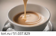 White cup of coffee is poured into it. Стоковое AI-видео, аниматор Данила Большаков / Фотобанк Лори